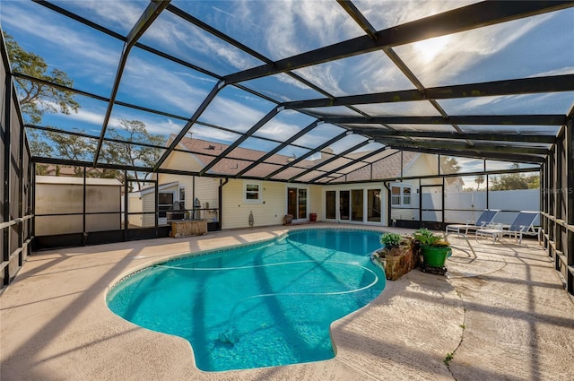 view of swimming pool with a patio area and glass enclosure