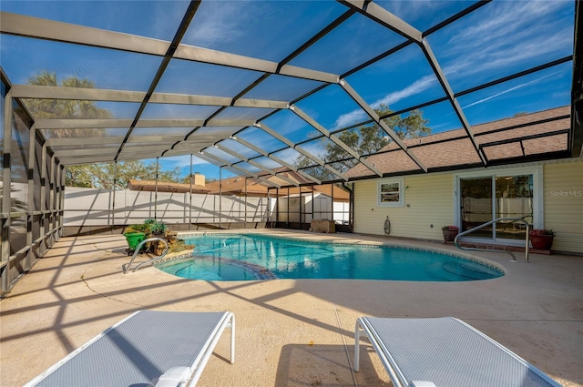 view of swimming pool featuring a lanai and a patio