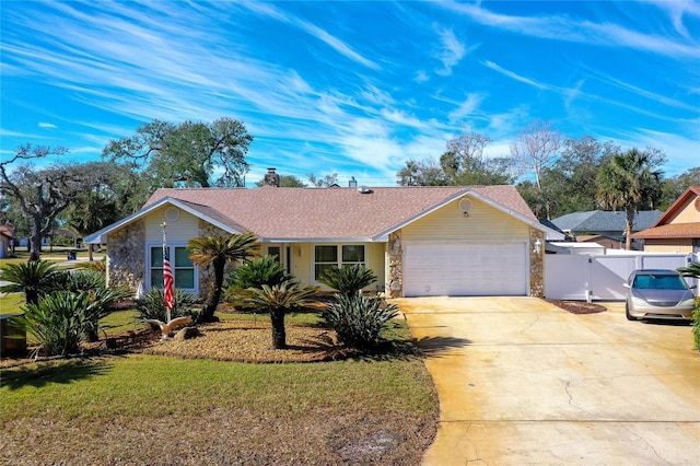 single story home featuring a garage and a front lawn