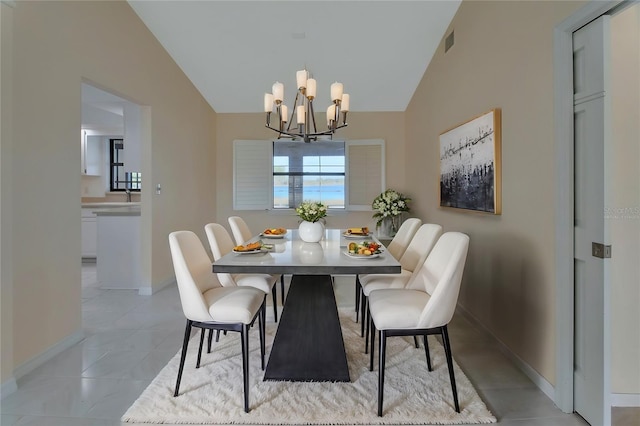 dining room with light tile patterned floors, high vaulted ceiling, and a chandelier