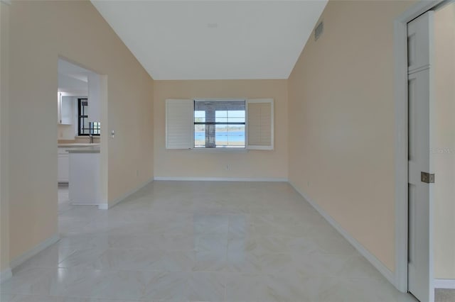 empty room with lofted ceiling