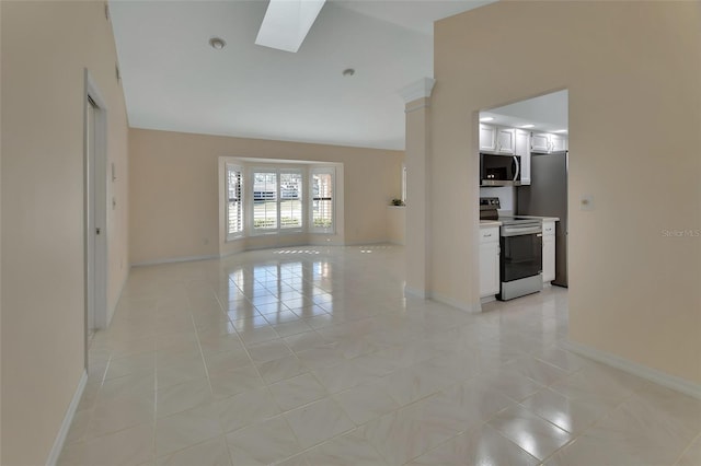 unfurnished living room featuring a skylight and high vaulted ceiling