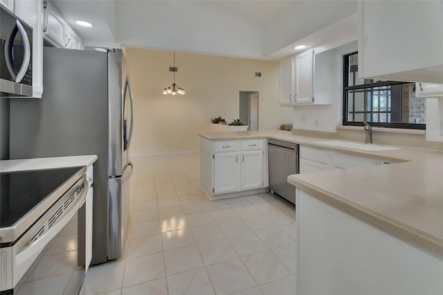 kitchen with sink, decorative light fixtures, stainless steel appliances, and white cabinets