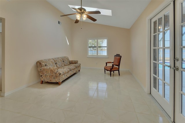 sitting room featuring vaulted ceiling, a water view, light tile patterned floors, and ceiling fan