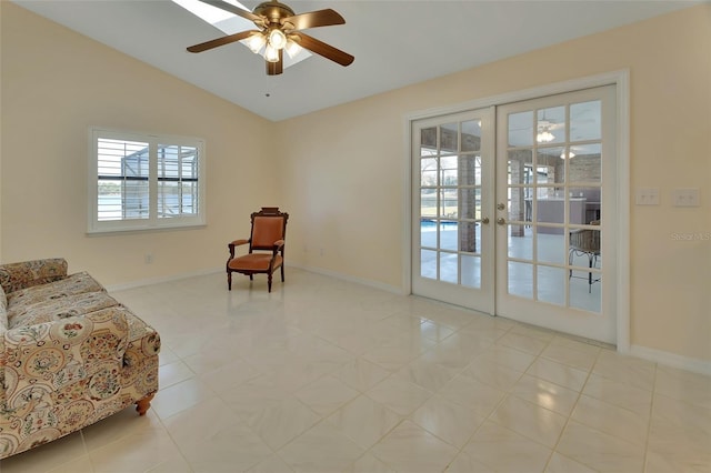 sitting room featuring lofted ceiling, a healthy amount of sunlight, light tile patterned floors, and french doors