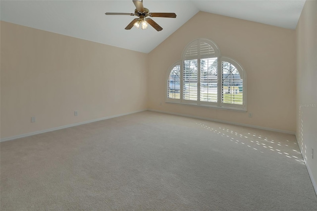 spare room featuring ceiling fan, light carpet, and high vaulted ceiling