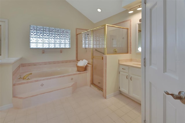 bathroom with lofted ceiling, vanity, and independent shower and bath