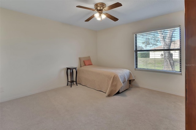 bedroom with light colored carpet and ceiling fan