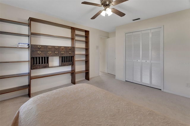 unfurnished bedroom with light carpet, ceiling fan, and a closet