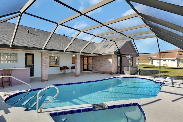 view of swimming pool with a patio, a lanai, and an outdoor bar