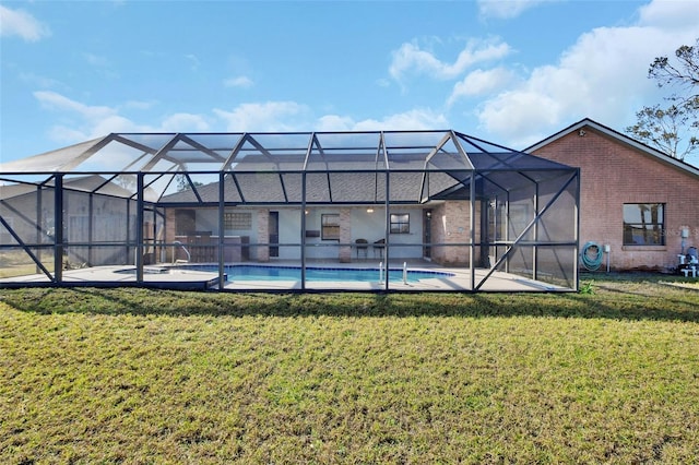 rear view of property featuring a patio, a lanai, and a yard