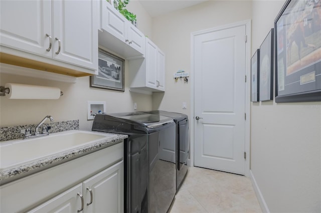 laundry area with sink, cabinets, washing machine and clothes dryer, and light tile patterned flooring