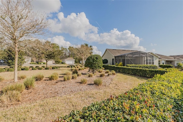 view of yard featuring glass enclosure