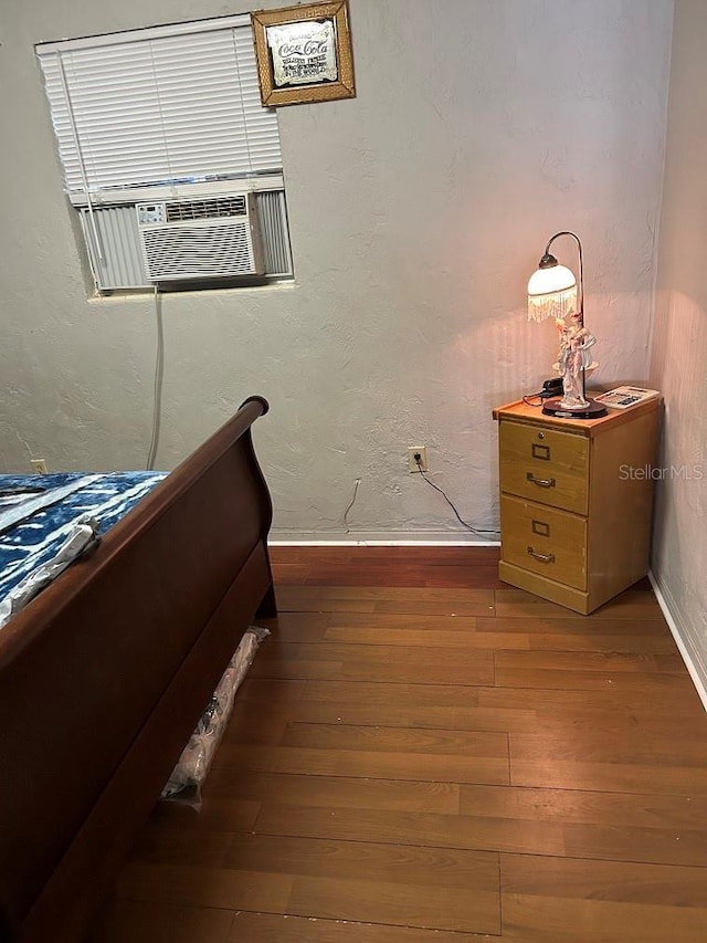 bedroom with dark hardwood / wood-style floors