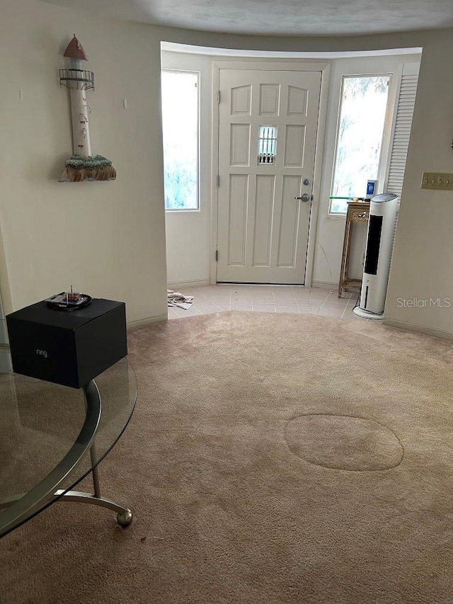 foyer entrance with light colored carpet