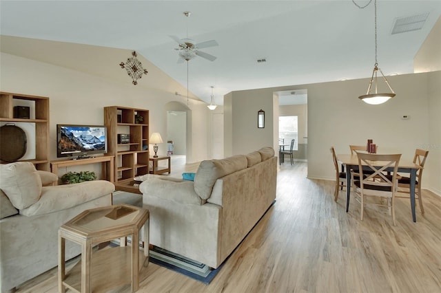 living room featuring lofted ceiling, light hardwood / wood-style floors, and ceiling fan