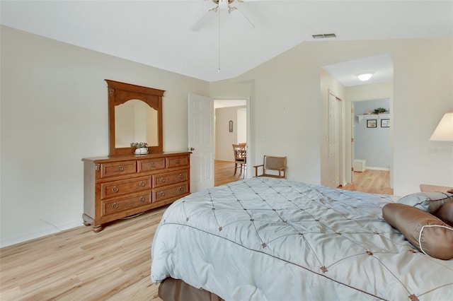 bedroom featuring ceiling fan, lofted ceiling, and light wood-type flooring