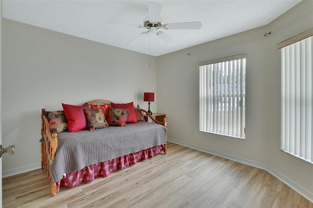 bedroom with ceiling fan and light wood-type flooring