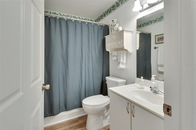 bathroom with vanity, hardwood / wood-style floors, and toilet