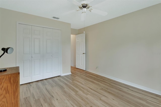 unfurnished bedroom featuring a closet, ceiling fan, and light hardwood / wood-style flooring