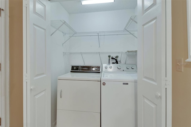 laundry area with washing machine and clothes dryer