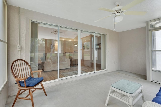 sunroom / solarium featuring ceiling fan