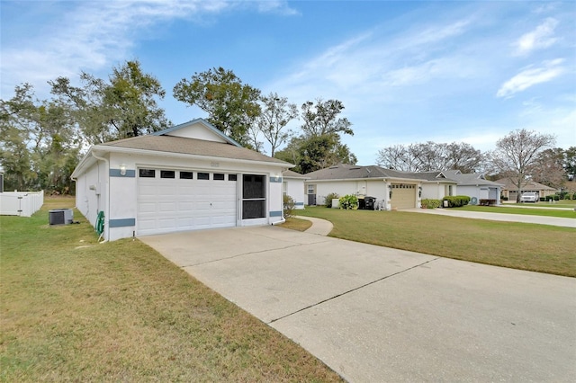 single story home with a garage, a front yard, and cooling unit