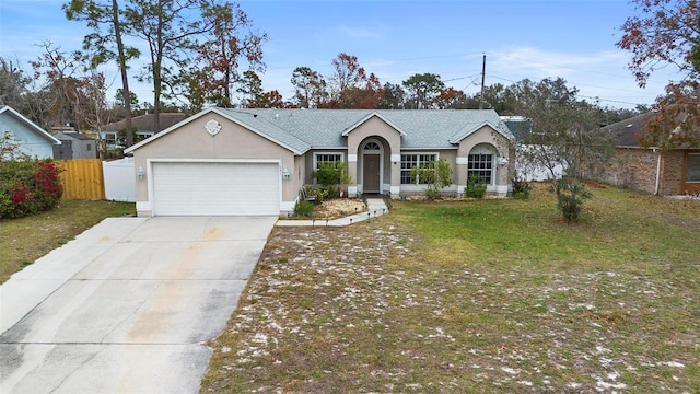 ranch-style home featuring a garage and a front yard