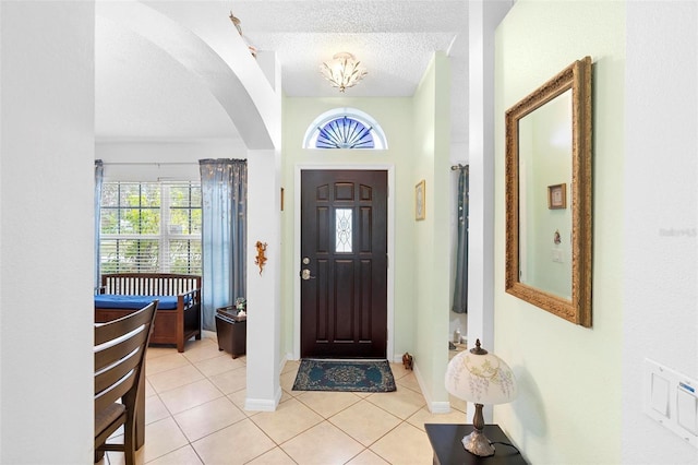 foyer featuring a textured ceiling and light tile patterned flooring