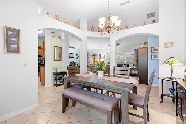 tiled dining area with high vaulted ceiling and a notable chandelier