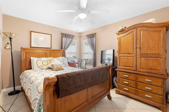 tiled bedroom featuring ceiling fan and a textured ceiling