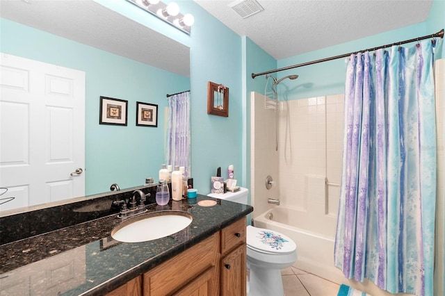 full bathroom with tile patterned flooring, vanity, toilet, a textured ceiling, and shower / bath combo with shower curtain