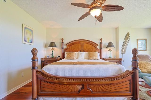 bedroom featuring dark hardwood / wood-style flooring, ceiling fan, and a textured ceiling