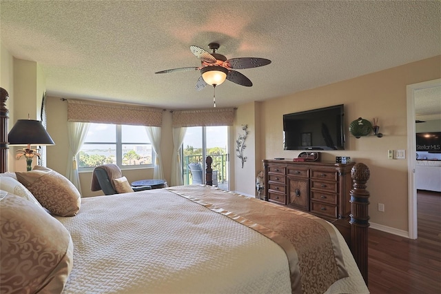 bedroom featuring ceiling fan, a textured ceiling, access to exterior, and dark hardwood / wood-style flooring