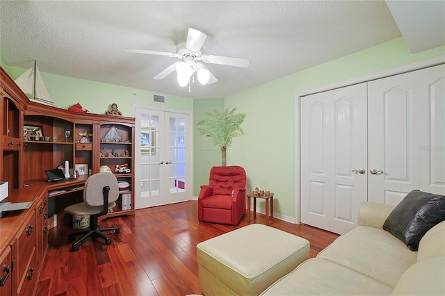 office area featuring ceiling fan, dark hardwood / wood-style floors, a textured ceiling, and french doors