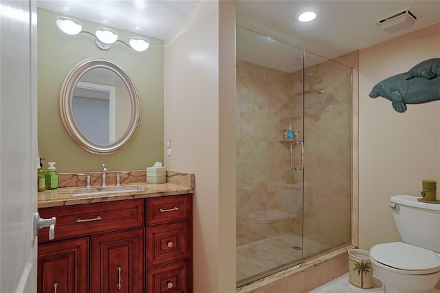 bathroom with vanity, toilet, and an enclosed shower