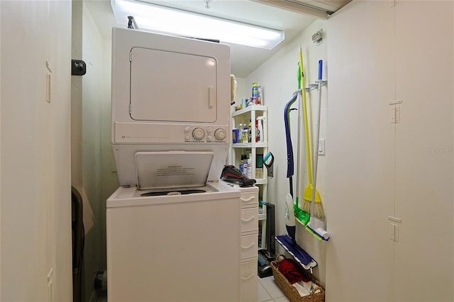 clothes washing area with stacked washing maching and dryer