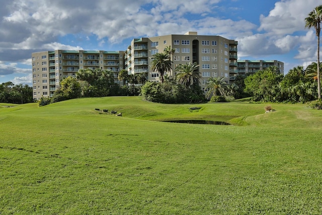 view of home's community with a yard