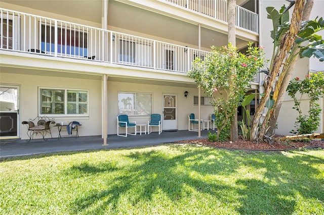 rear view of property with a yard and a patio