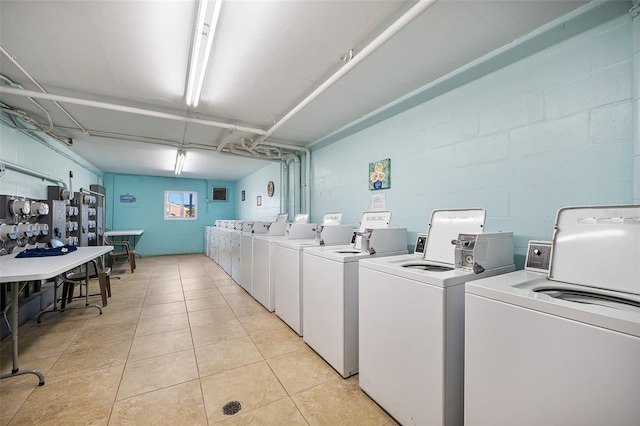 laundry room featuring light tile patterned floors and washing machine and dryer