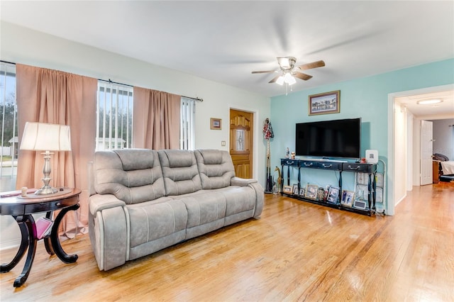 living area featuring a ceiling fan and wood finished floors