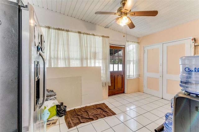 interior space featuring wooden ceiling, a ceiling fan, and light tile patterned floors