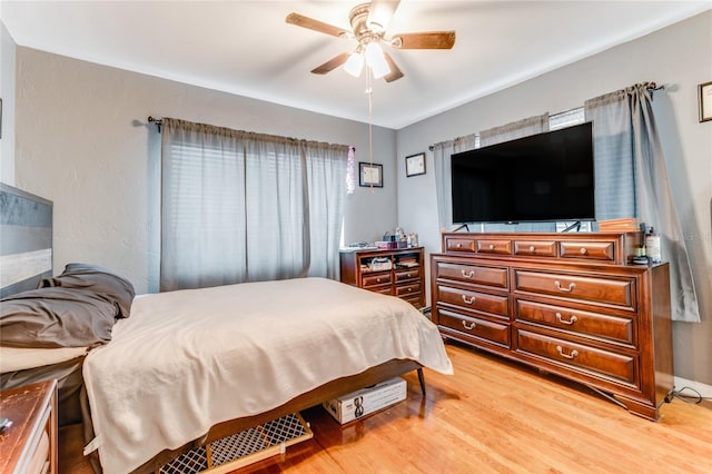 bedroom with a ceiling fan and light wood finished floors