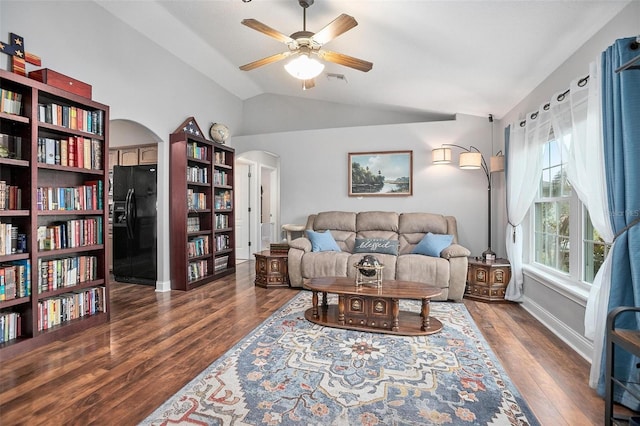 living room with ceiling fan, lofted ceiling, and dark hardwood / wood-style floors