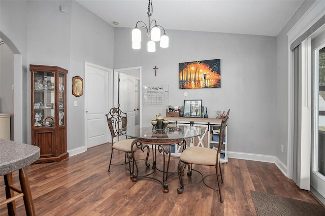 dining space with lofted ceiling, a chandelier, and dark hardwood / wood-style flooring