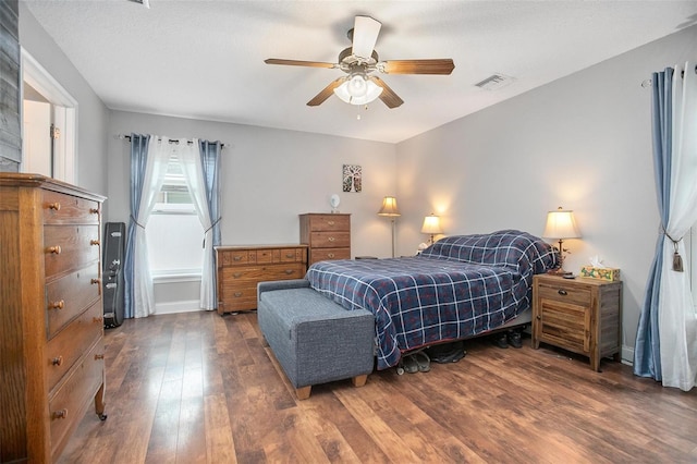 bedroom with dark wood-type flooring and ceiling fan