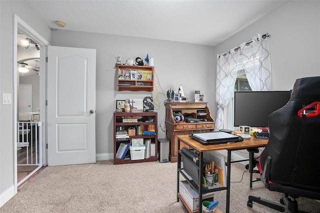 carpeted office space with a textured ceiling