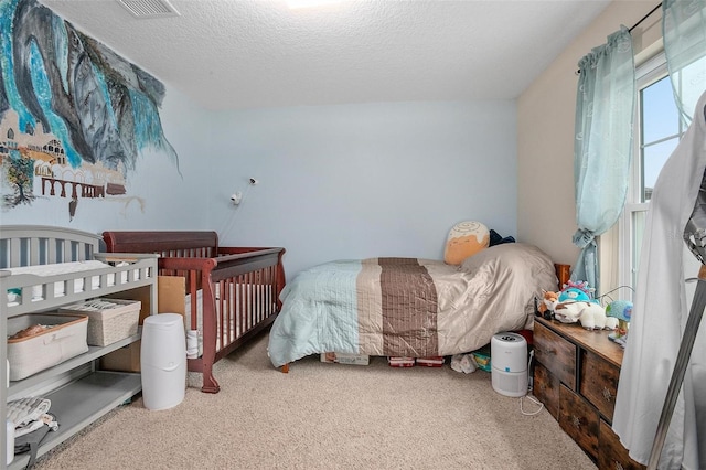 carpeted bedroom featuring a textured ceiling