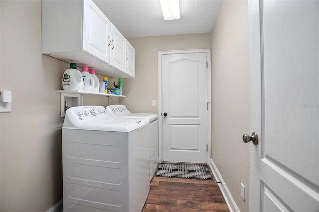 laundry room with cabinets, separate washer and dryer, dark hardwood / wood-style floors, and a textured ceiling