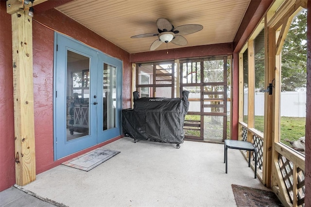 sunroom with french doors, ceiling fan, and wood ceiling